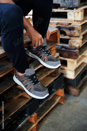 Photo of a man tying her shoes, at that time she was running in the morning wearing sports shoes or sneakers         