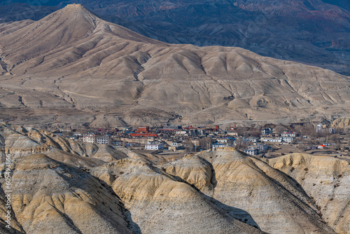 Lo Manthang, capital of Upper Mustang, viewed from a distance amidst a barren desertic landscape, Kingdom of Mustang, Himalayas, Nepal, Asia photo
