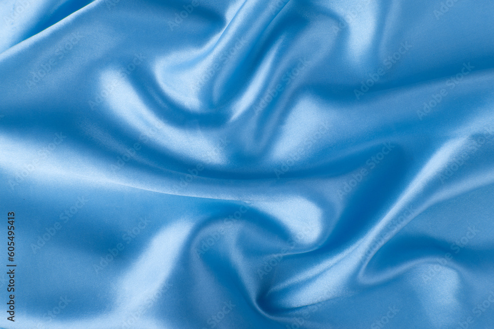 Obraz premium Abstract blue silk fabric texture background. Creases of satin 
