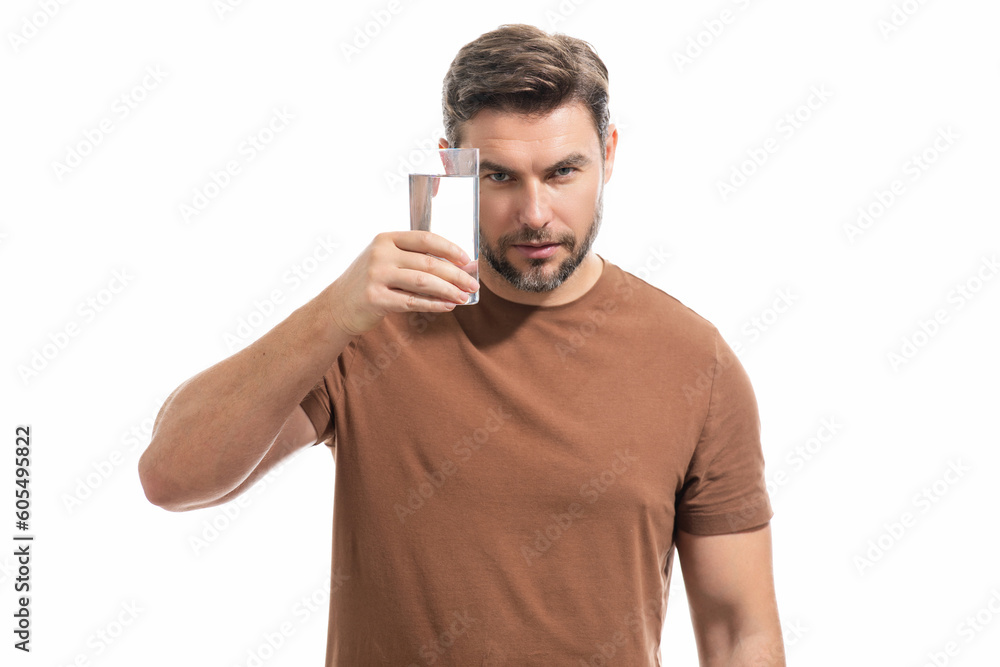 Man drinking fresh water isolated on studio background. Man holds glass of water. Mineral water refreshment, daily aqua, dehydration. Portrait of man drinking water. Man drinking fresh water isolated on studio background. Man holds glass of water. Mineral water refreshment, daily aqua, dehydration. Portrait of man drinking water.