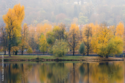 Reflections of colorful trees on Shooters Island (Strelecky ostrov) on Vltava River in autumn, Prague, Czech Republic (Czechia), Europe photo