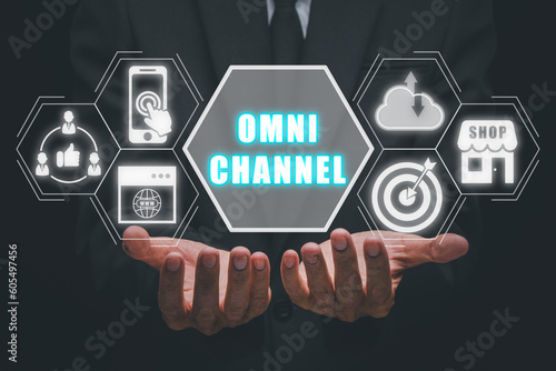 Omni channel concept, Person hand holding omni channel icon on virtual screen. photo