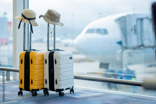 Two suitcases in empty airport hall, traveller cases in departure airport terminal waiting area, vacation concept, blank space for text message or design