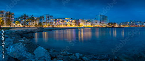 View of Platja de ses Figueretes Beach at dusk, Ibiza Town, Ibiza, Balearic Islands, Spain, Mediterranean, Europe photo