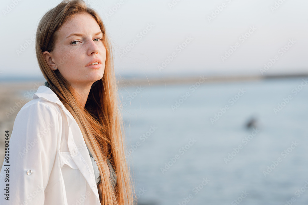 Portrait of a beautiful red-haired girl on the beach. Portrait of a beautiful red-haired girl on the beach.