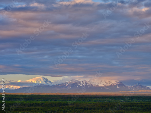 Snow and cloud covered Mount Logan part of the Wrangell-St. Elias Mountain range in Alaska at sunset