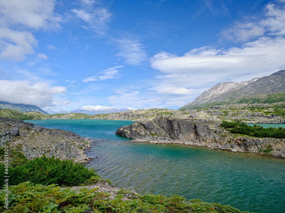Fototapeta premium Beautiful Blue-green water of Bernard Lake on the Klondike Highway in Aiyansh British Columbia Canada and the rugged landscape surrounding the lake