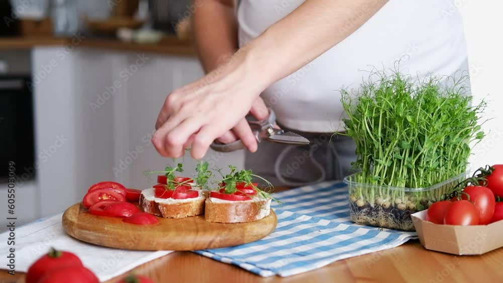 Pregnant young woman preparing healthy sandwiches with microgreens and vegetables. Food rich in fiber Pregnant young woman preparing healthy sandwiches with microgreens and vegetables. Food rich in fiber