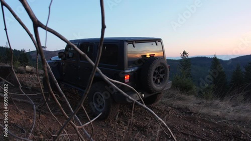 Jeep Wrangler driving through difficult gravel road in the mountains. Washington State, USA - circa 2022.