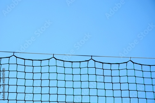 The top of the fence mesh hanging on a wire © Gold Picture