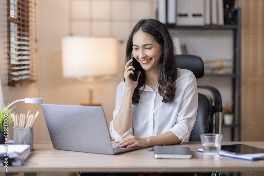 Happy caucasian young Asian woman using smart phone cellphone for calls, social media, mobile application online in office money financial planning Business And Education Concept. Happy caucasian young Asian woman using smart phone cellphone for calls, social media, mobile application online in office money financial planning Business And Education Concept.