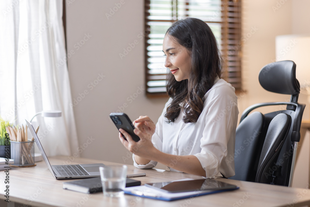 Happy caucasian young Asian woman using smart phone cellphone for calls, social media, mobile application online in office money financial planning Business And Education Concept. Happy caucasian young Asian woman using smart phone cellphone for calls, social media, mobile application online in office money financial planning Business And Education Concept.