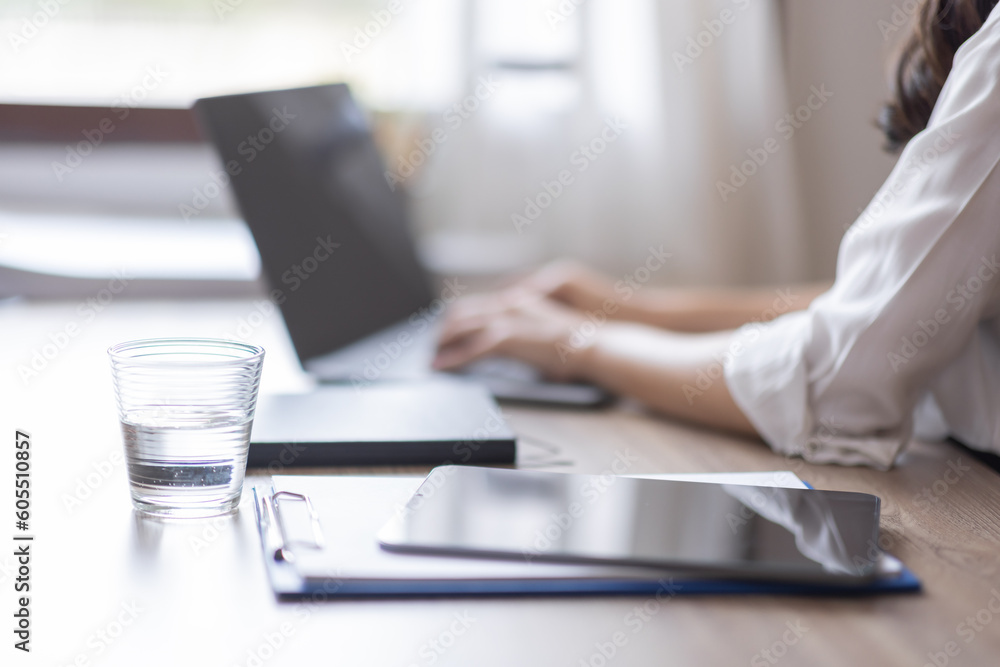 Business And Education Concept. Smiling young asian woman sitting at desk working on laptop writing letter in paper documents, free copy space. Happy millennial female studying using laptop Business And Education Concept. Smiling young asian woman sitting at desk working on laptop writing letter in paper documents, free copy space. Happy millennial female studying using laptop