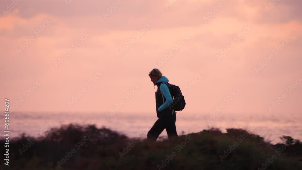 Solo female hiker walking desert ocean coastal path Solo female hiker walking desert ocean coastal path