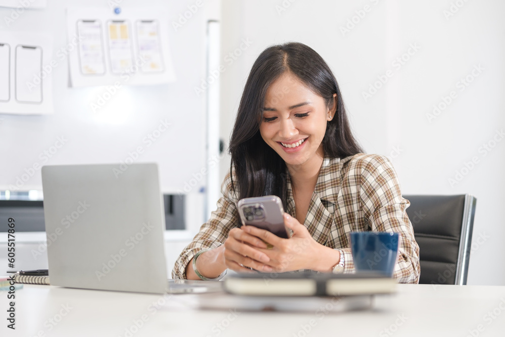 Portrait of young woman designer using smartphone at office. Technology and user interface design concept Portrait of young woman designer using smartphone at office. Technology and user interface design concept