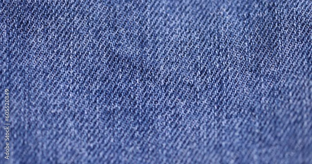 close-up of a new blue denim fabric, part of a pair of blue denim pants close-up of a new blue denim fabric, part of a pair of blue denim pants