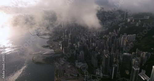 Aerial panning shot of Wan Chai district under low clouds during sunrise. Hong Kong Island photo