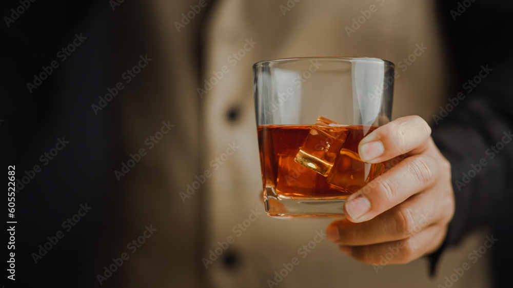 Bartender serving whiskey on wooden bar ,Close-up shot of whiskey glass