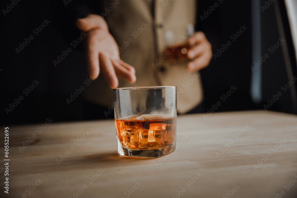 Bartender serving whiskey on wooden bar ,Close-up shot of whiskey glass Bartender serving whiskey on wooden bar ,Close-up shot of whiskey glass