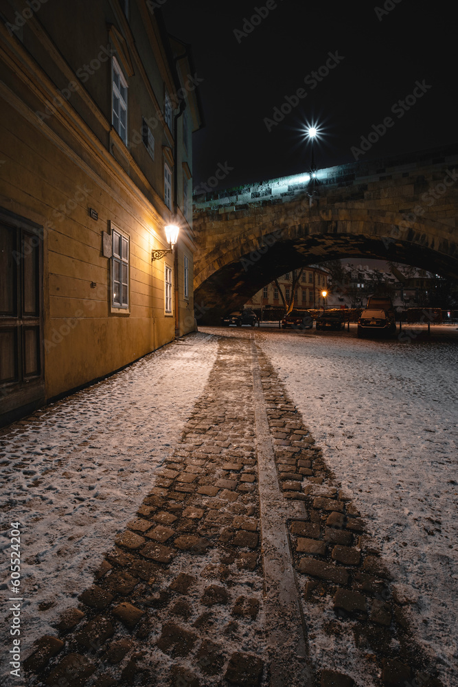 Snowy Streets of Prague with Illuminated Street Lights at Night
