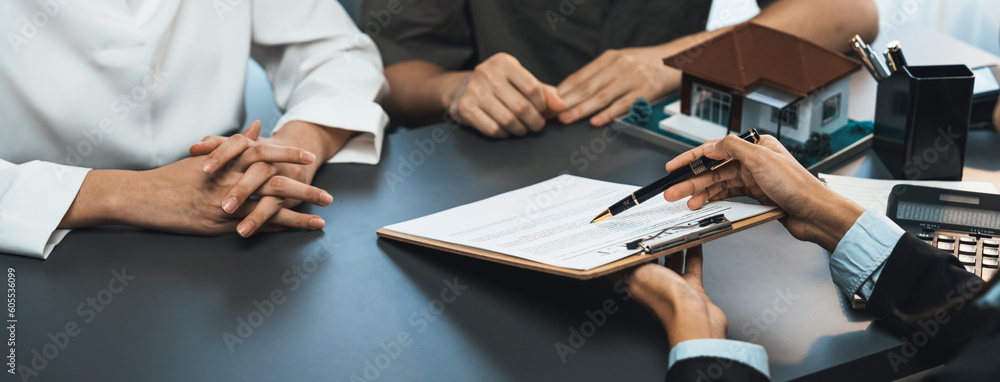 Client review loan contract with real estate agent, discussing term, interest and property ownership. Analyzing legal document, reading agreement before deciding. Real estate panorama image. Prodigy - obrazy, fototapety, plakaty 