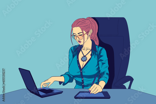 Young female office worker sitting at working desk and working on laptop and graphics tablet