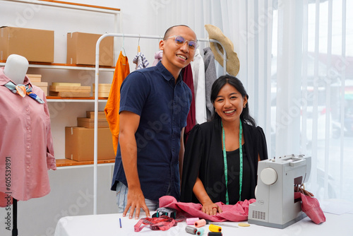 A young couple of designer working together in a boutique. Young entrepreneurs running their own business in Indonesian