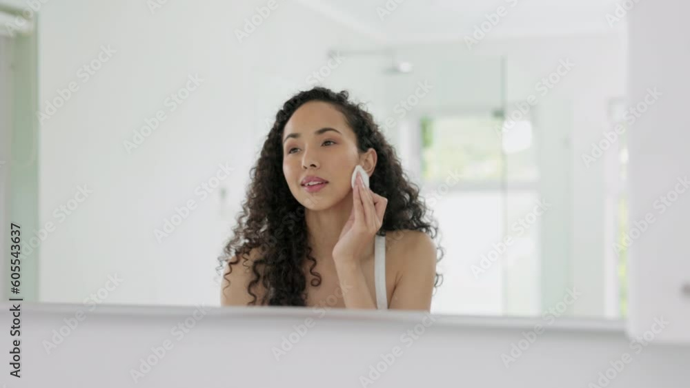 Woman, beauty and cotton pad for makeup removal, cleanse or facial treatment in bathroom at home. Female person cleaning face with cosmetic swab in mirror for dermatology, hygiene or exfoliate Woman, beauty and cotton pad for makeup removal, cleanse or facial treatment in bathroom at home. Female person cleaning face with cosmetic swab in mirror for dermatology, hygiene or exfoliate