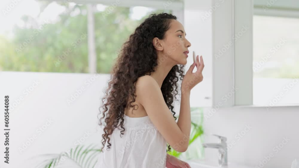 Woman, beauty and cotton swab in mirror for makeup removal, skincare or cosmetics in bathroom at home. Female person cleaning or wiping face with pad to remove products, facial treatment or cleanse