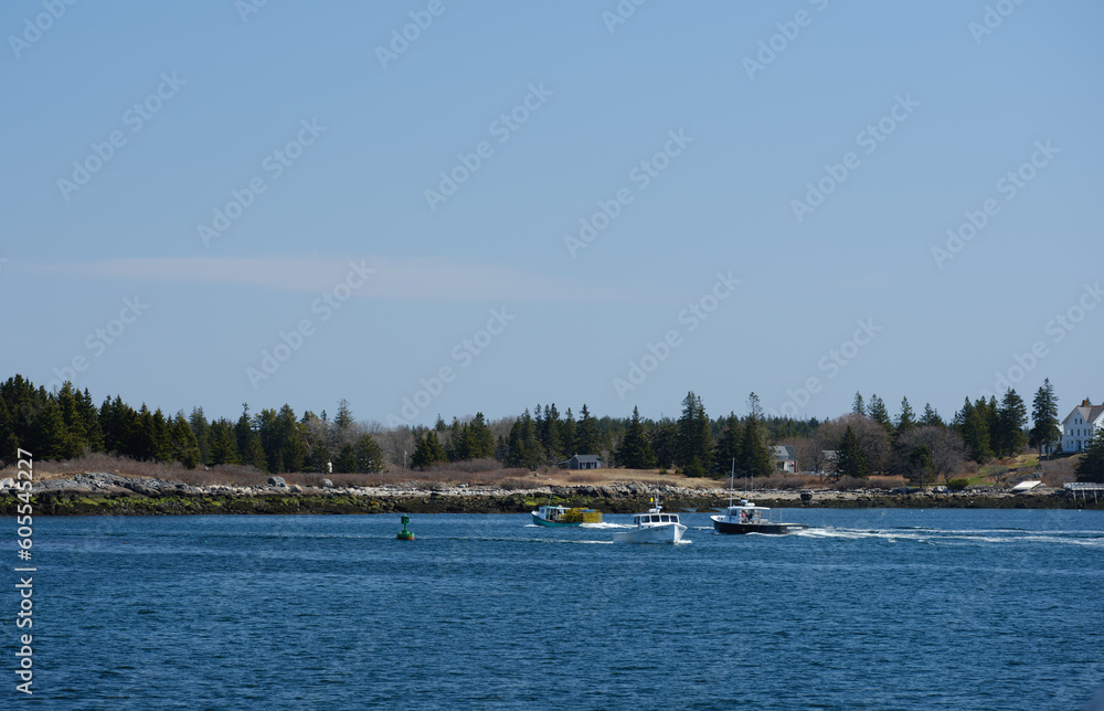 Obraz premium Lobster boats coming into and out of the North Haven harbor on Vinalhaven Island in Maine