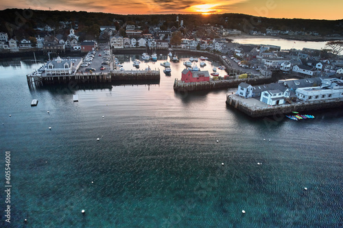 Aerial drone image of the entrance to Rockport Massachusetts harbor at sunset