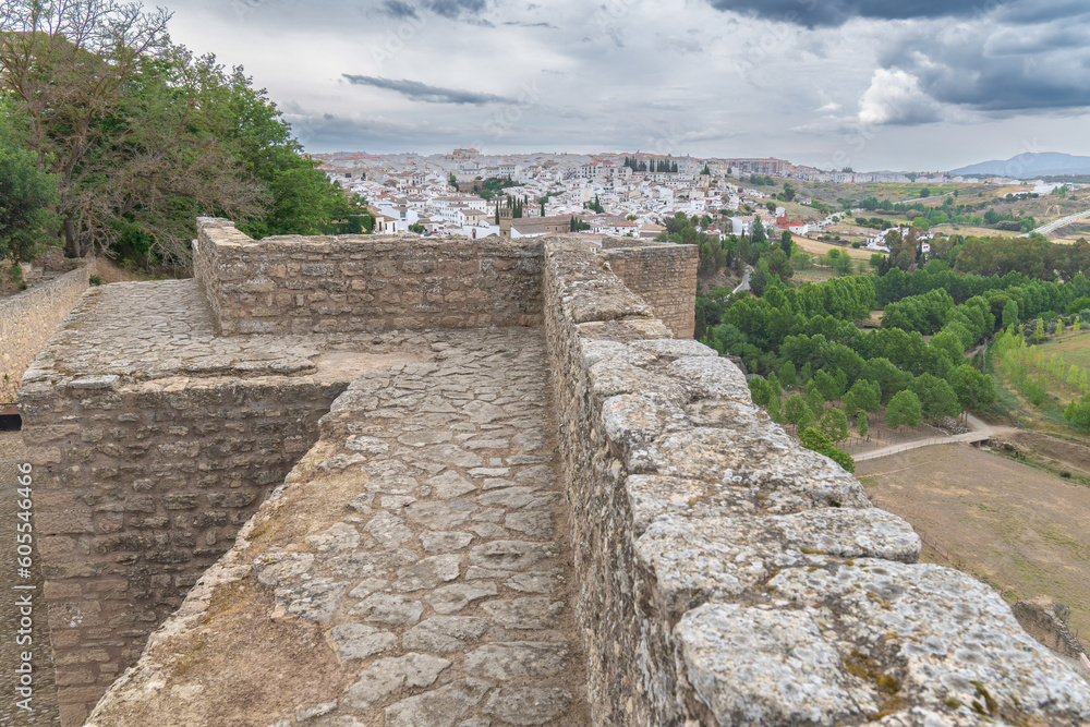view of the city of ronda from the defensive walls of the city on a day of cloudy stormy sky