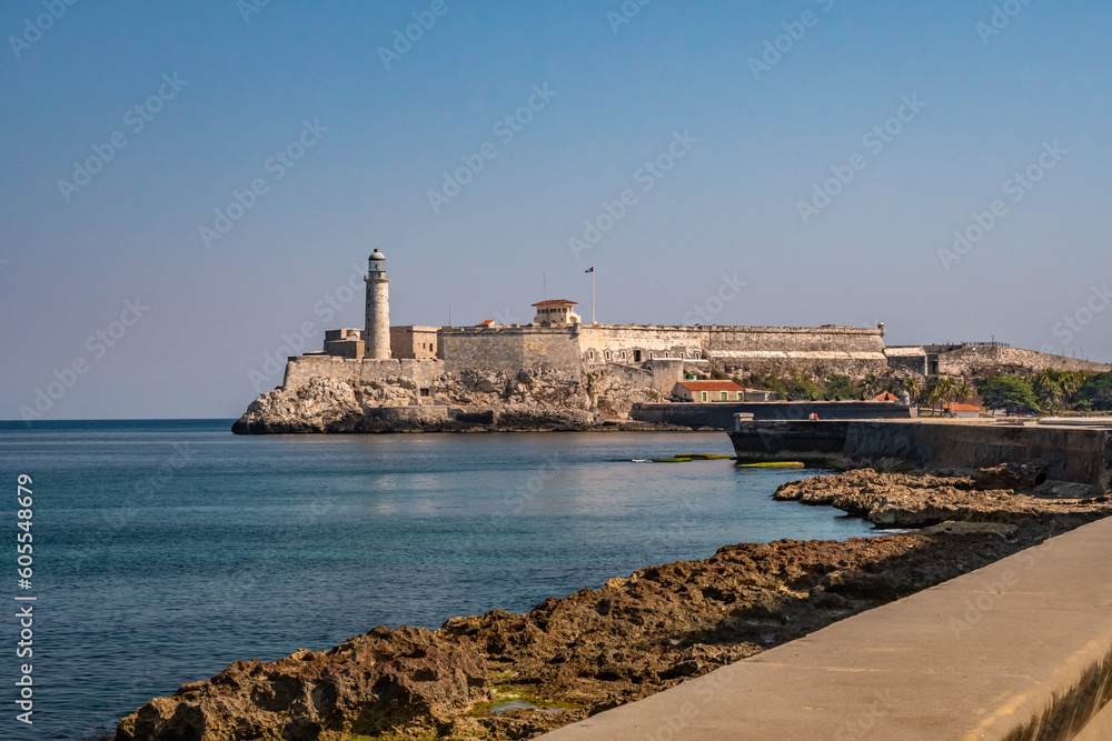 The Malecon waterfront with the three kings castle lighthouse in Havana, Cuba