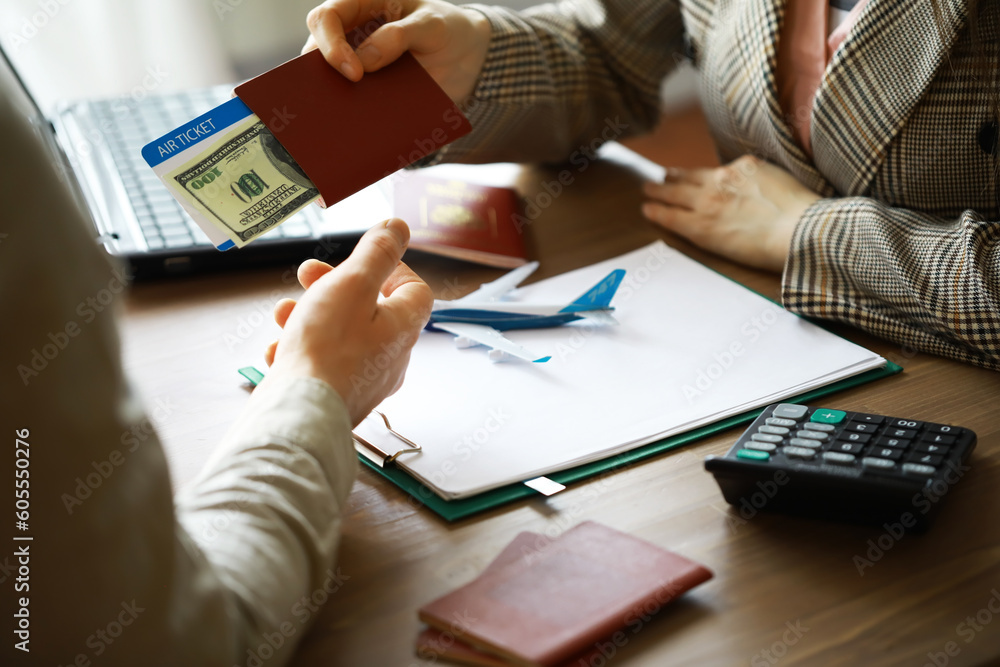 Travel agent receiving money from client for provided service in office Travel agent receiving money from client for provided service in office