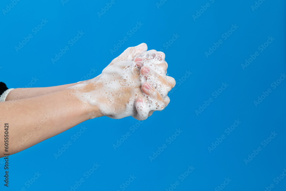Woman washing nails on blue background Woman washing nails on blue background