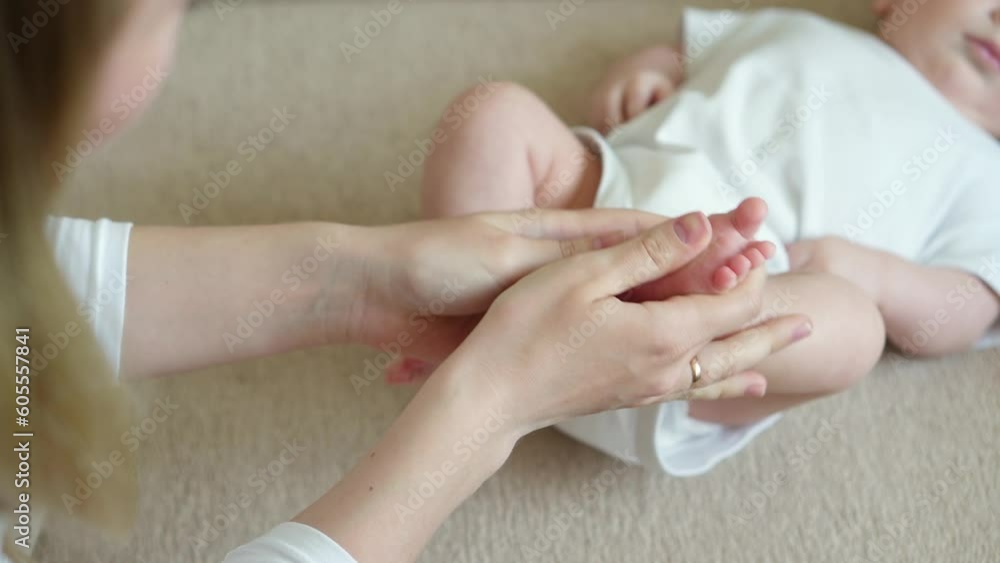 Mom massages the baby legs. Children massage.The concept of babysitting,maternity leave,masseur.Prevention of flat feet Mom massages the baby legs. Children massage.The concept of babysitting,maternity leave,masseur.Prevention of flat feet