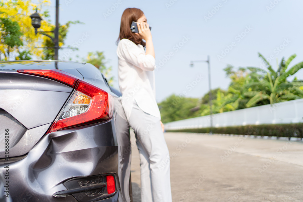 Naklejka premium Upset unhappy Asian woman have a car accident or crashed during her road trip.