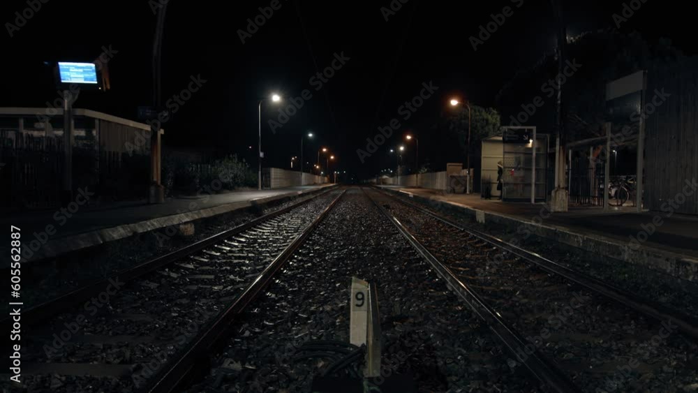 Very center of railway road in suburbs station at night Very center of railway road in suburbs station at night