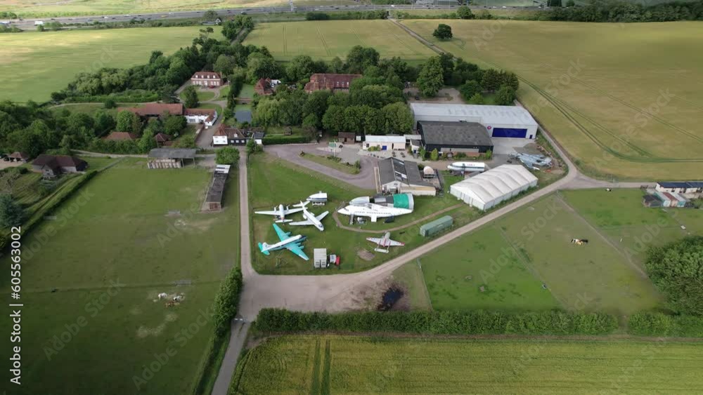 Aerial view orbiting De Havilland Mosquito and Vampire preserved aircraft collection outside historical Hertfordshire museum Aerial view orbiting De Havilland Mosquito and Vampire preserved aircraft collection outside historical Hertfordshire museum