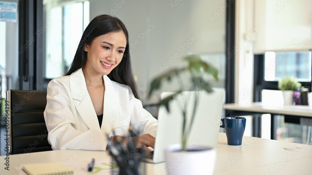 A businesswoman working on her business works on laptop in her office. A businesswoman working on her business works on laptop in her office.