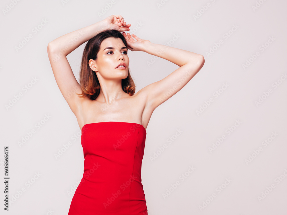 Young beautiful smiling female in trendy summer red evening dress. Sexy carefree brunette woman posing in studio, isolated on white. Positive model with evening makeup. Cheerful and happy Young beautiful smiling female in trendy summer red evening dress. Sexy carefree brunette woman posing in studio, isolated on white. Positive model with evening makeup. Cheerful and happy