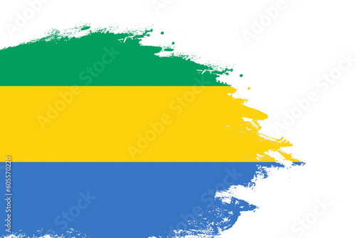 Gabon flag on a stained stroke brush painted isolated white background with copy space