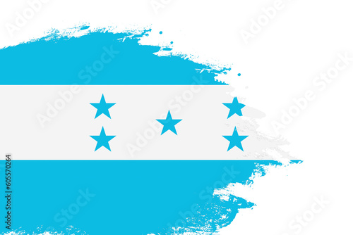 Honduras flag on a stained stroke brush painted isolated white background with copy space