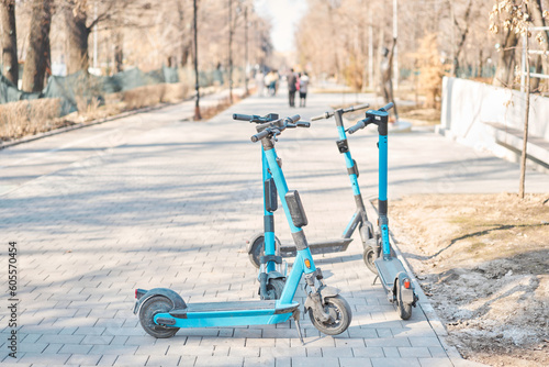  Public mobile transport. urban eco-friendly transport for rent. Electric Scooters For Public Use, Standing On The Street In The City Center.