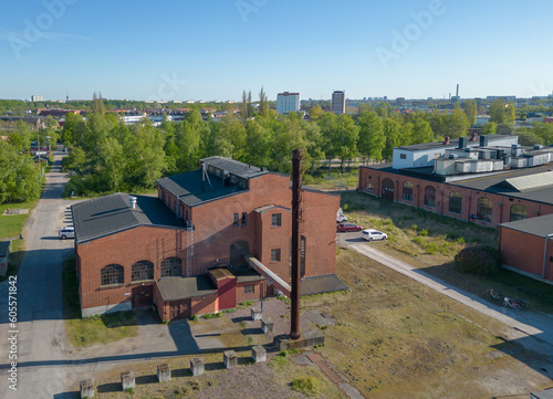 A vintage factory in Malmö, Sweden made of red bricks with a chimney. 