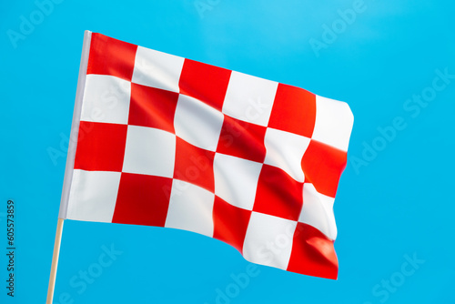 Checkered flag waving on blue background