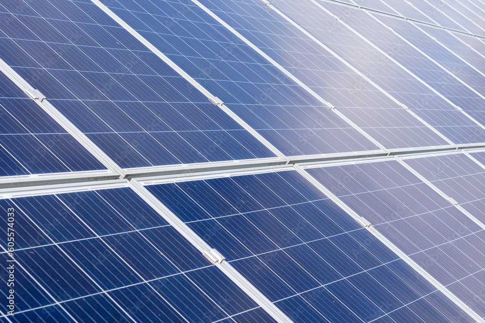 Solar Panels And Wind Turbines In Grassy Field With Sunlight - Renewable Energy Concept Solar Panels And Wind Turbines In Grassy Field With Sunlight - Renewable Energy Concept