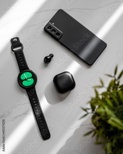 Tableau sur toile Smartwatch, earbuds and pone on marble table