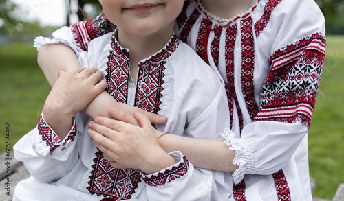 hands of two children, dressed in traditional embroidered Ukrainian clothes, hold each other. nation concept. Family, unity, support, patriotism, Stop the war in Ukraine. be proud and love Ukraine
