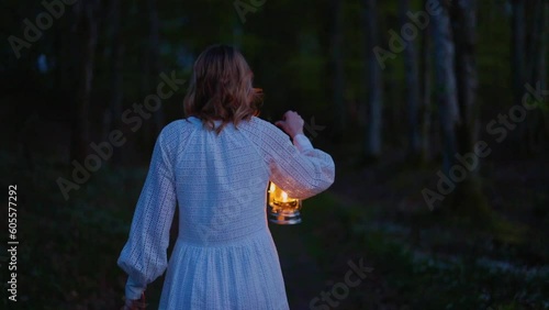 girl walking alone with lamp